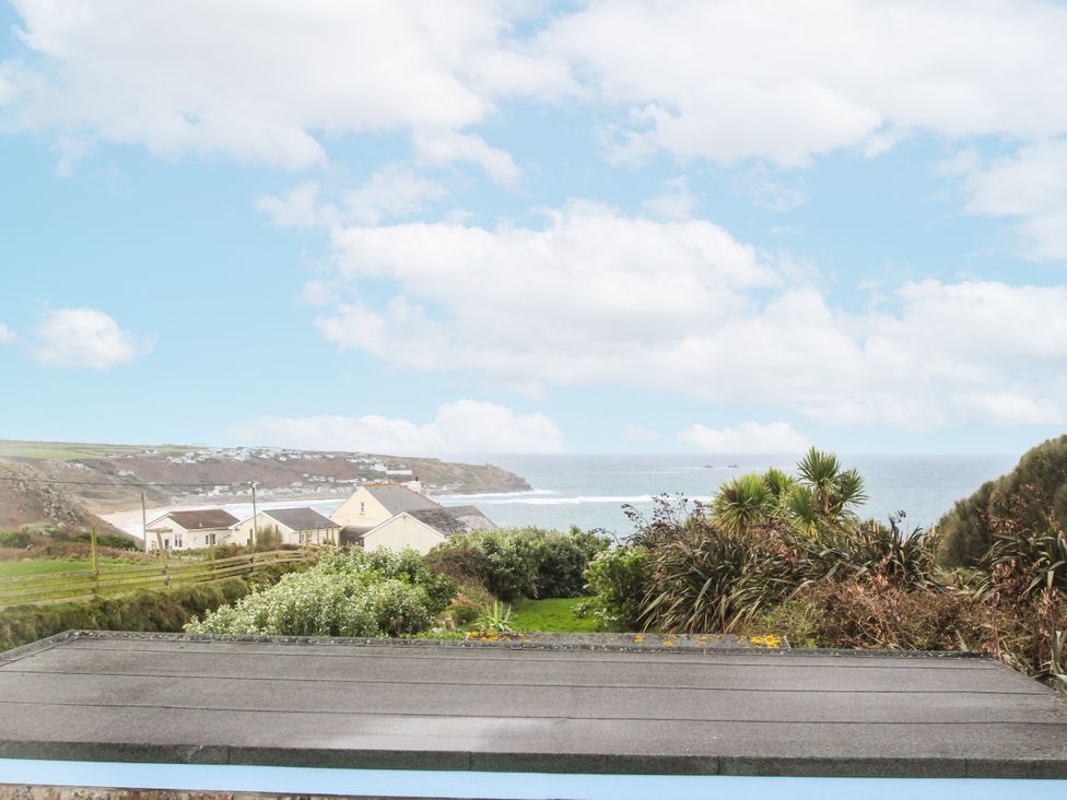 A view of the ocean and houses at Tregiffian Vean in Sennen Cove