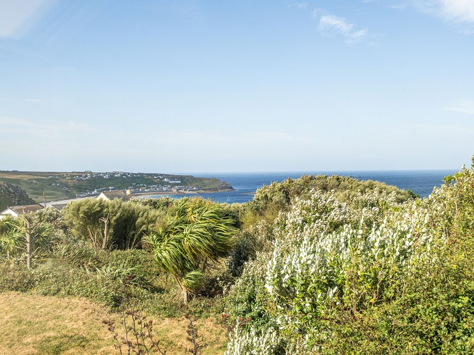 A coastal view with plants and houses at Tregiffian Vean in Sennen Cove