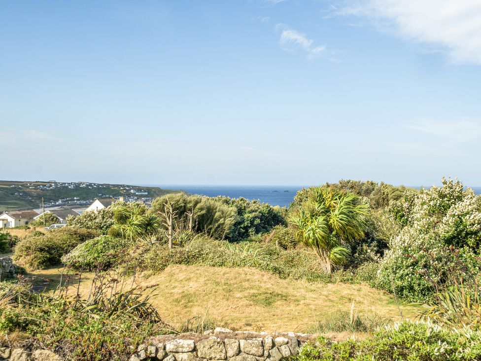 A view of the ocean and greenery at Tregiffian Vean in Sennen Cove