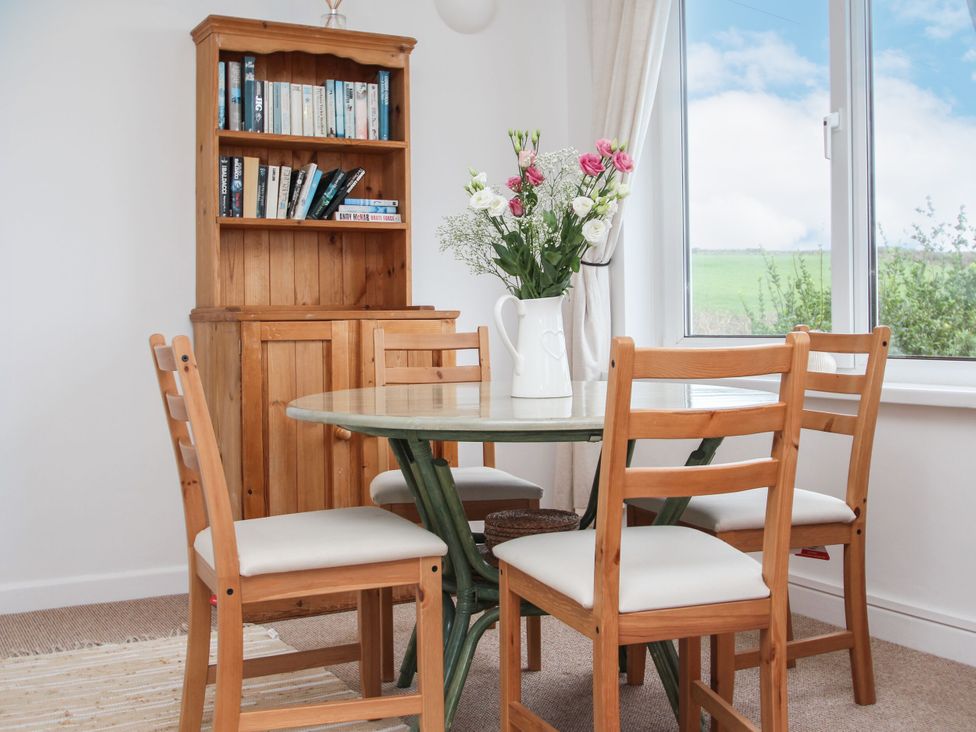 A dining room with a table and chairs at The Lookout in Sennen