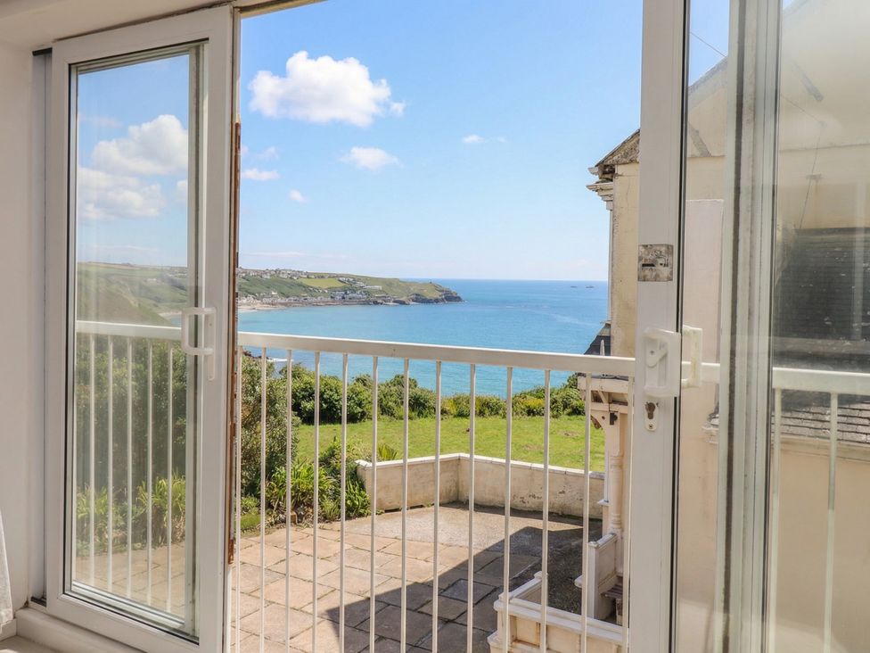 A balcony with glass doors overlooking the sea at Brook House Sennen Cove near St Just