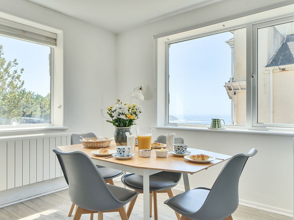 A dining room with a table set for breakfast at Brook House in Sennen Cove near St Just