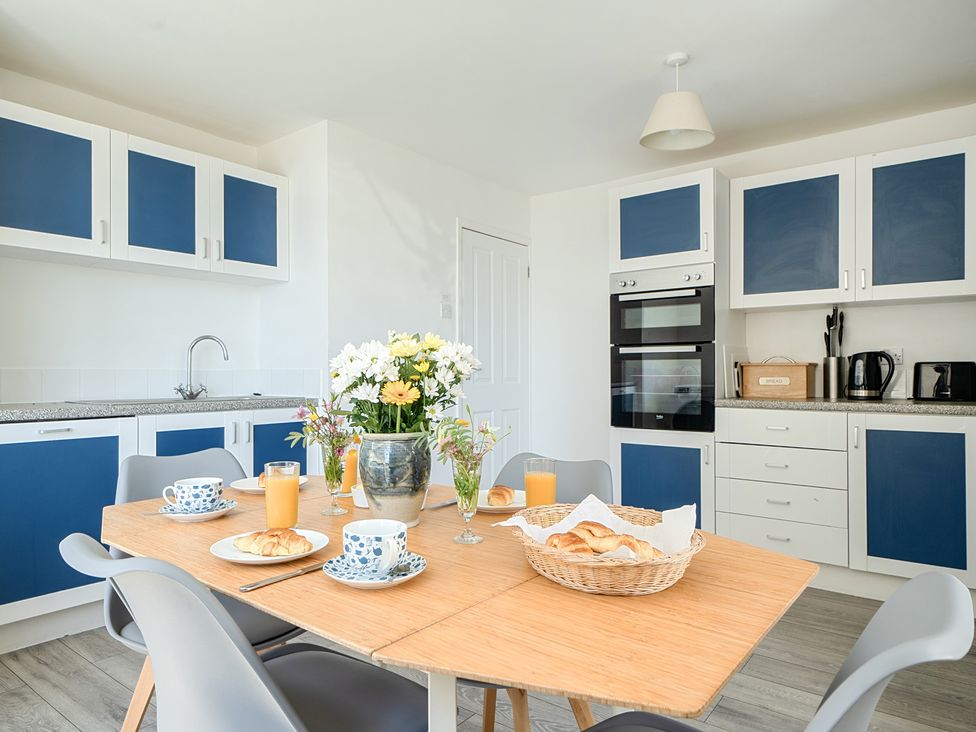 A kitchen with a dining table and chairs at Brook House in Sennen Cove near St Just