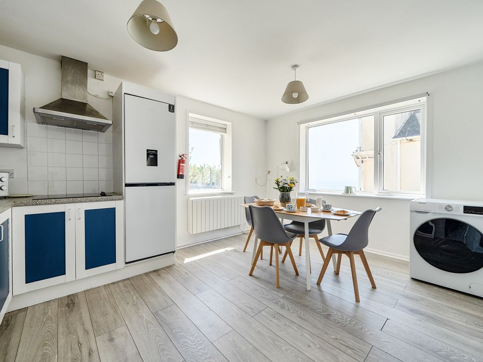 A kitchen with table and chairs at Brook House in Sennen Cove near St Just