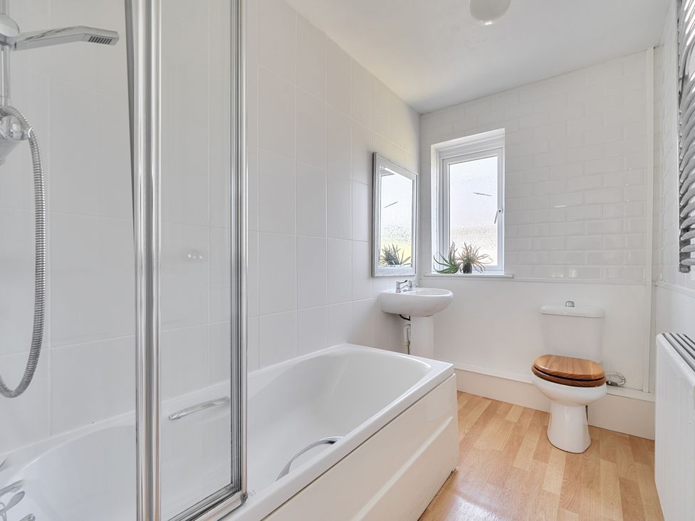 A bathroom with a bathtub and a sink at Brook House Sennen Cove near St Just