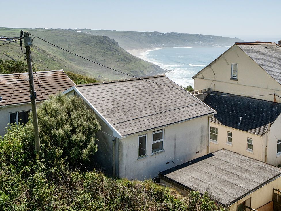 A view of houses and cliffs near the ocean at Brook House in Sennen Cove near St Just