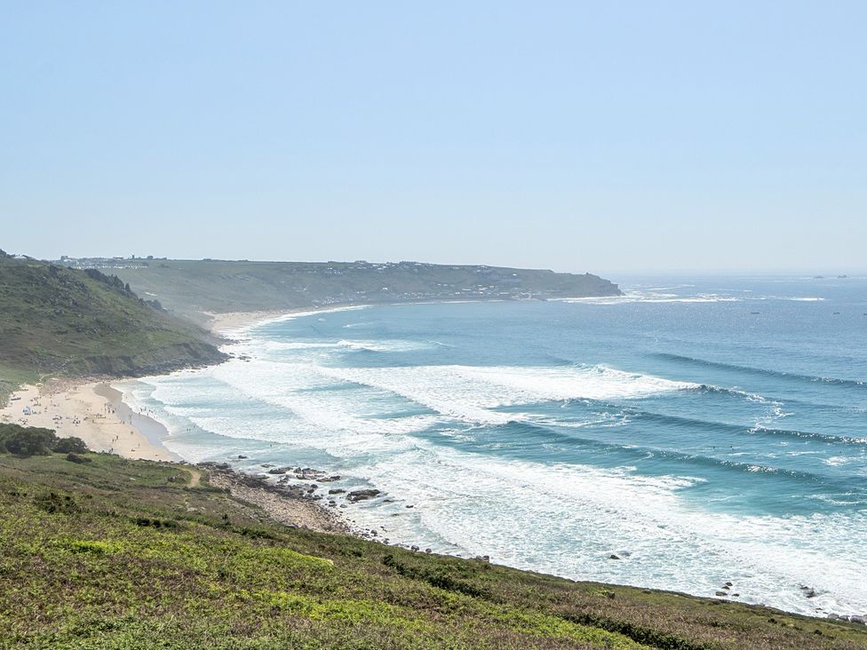 A coastal view with waves and beach at Brook House in Sennen Cove near St Just