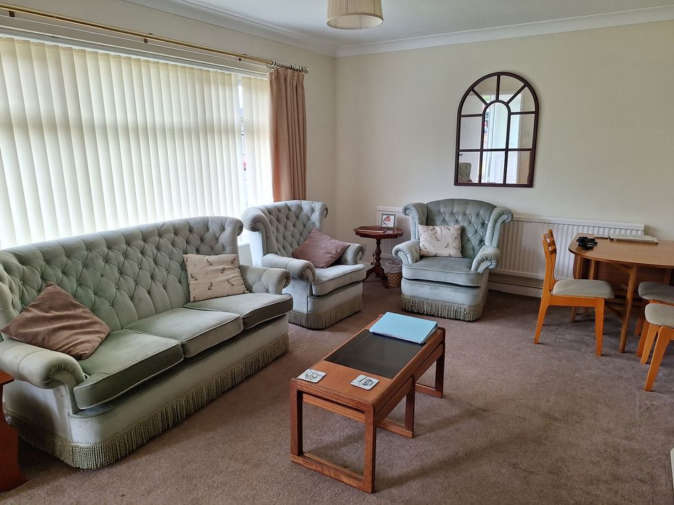 A living room with sofas and a table at Newby in Gayton near King's Lynn