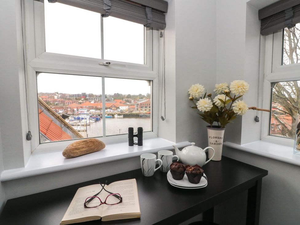 A kitchen table with a teapot and snacks at Kirkby House in Whitby