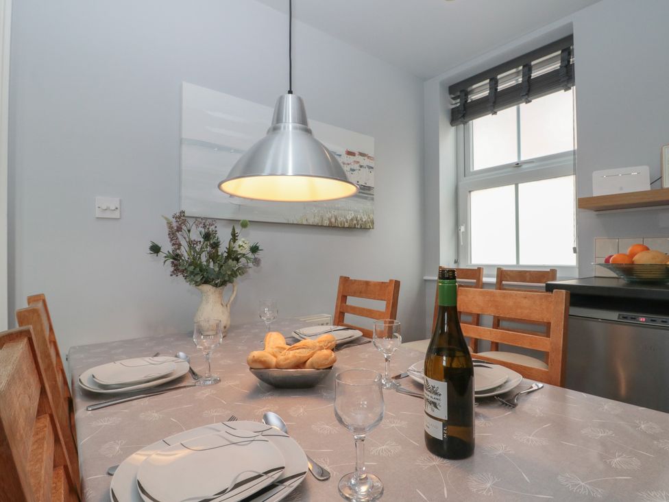A dining room with a table set for meals at Kirkby House in Whitby