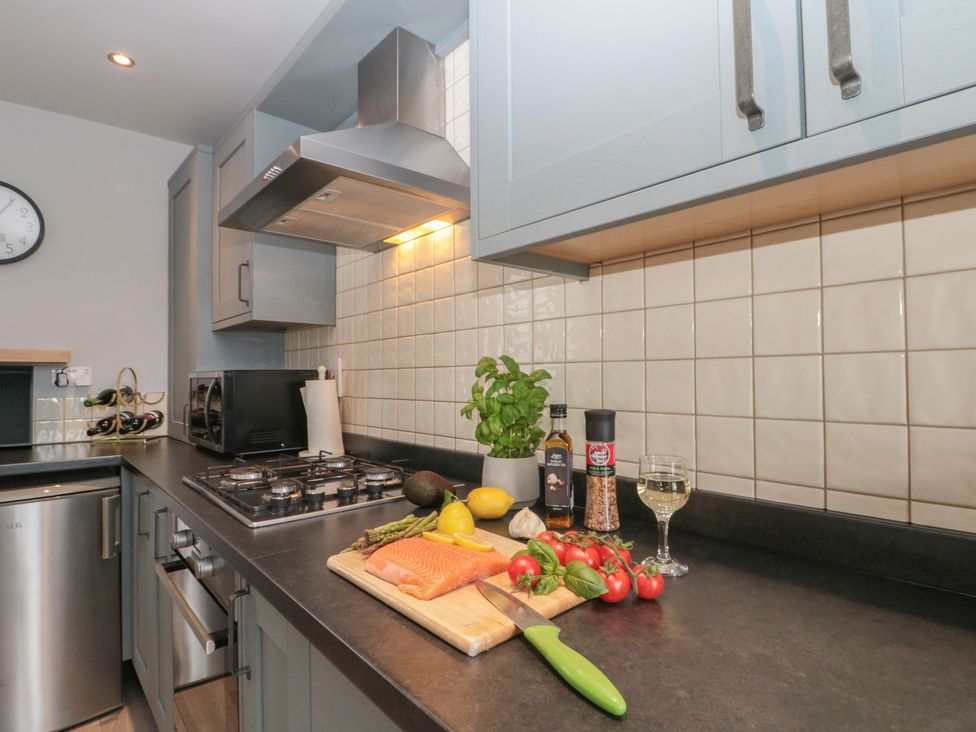 A kitchen with a stove and cutting board at Kirkby House in Whitby