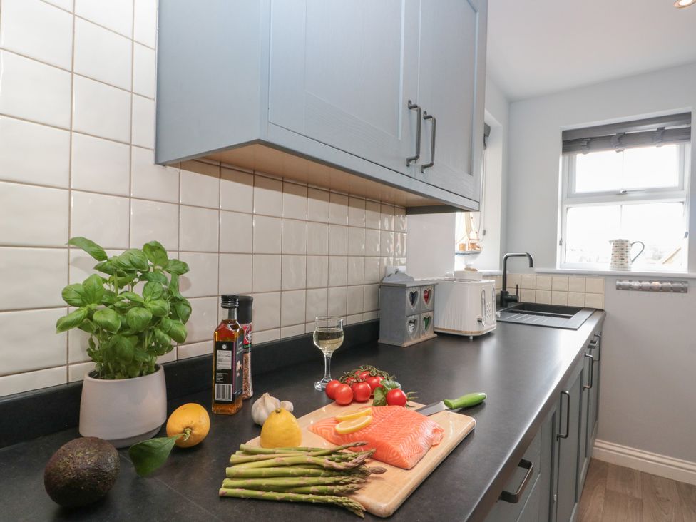 A kitchen with a cutting board and ingredients at Kirkby House in Whitby