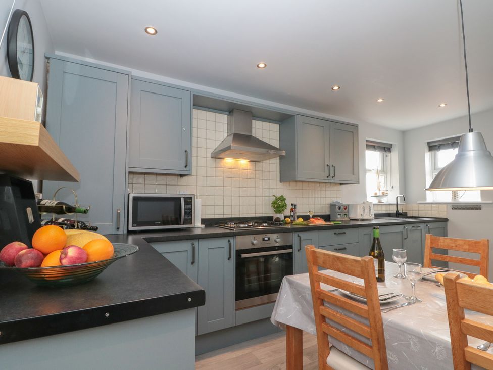 A kitchen with cabinets and appliances at Kirkby House in Whitby