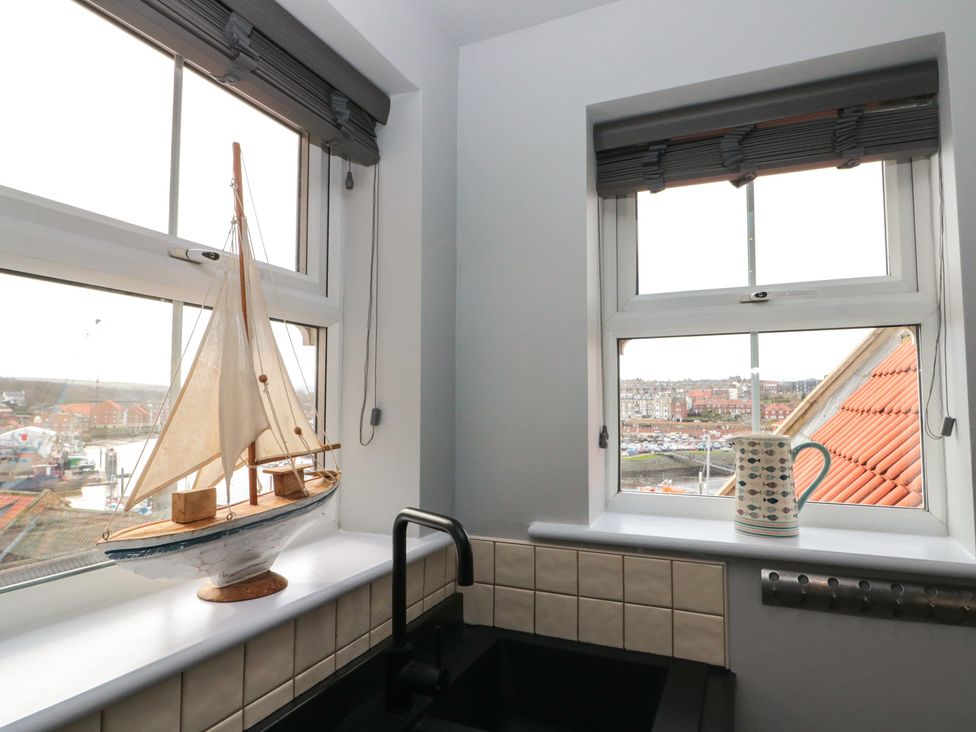 A kitchen with a sailboat on the windowsill at Kirkby House in Whitby
