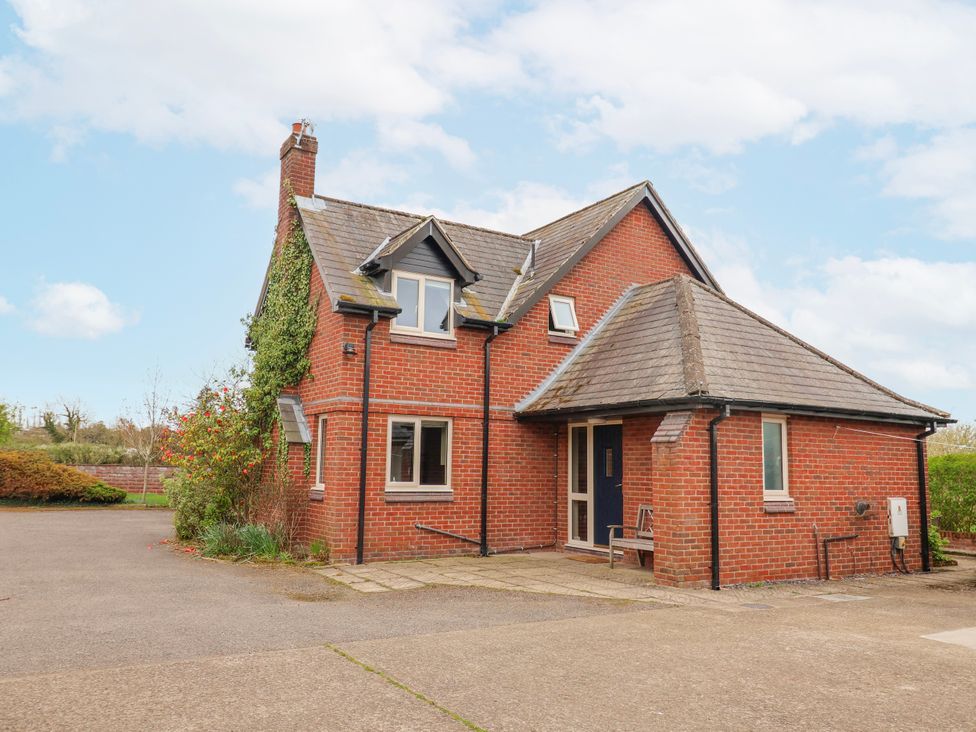 A house with a garden and driveway at Manor Wood Farndon