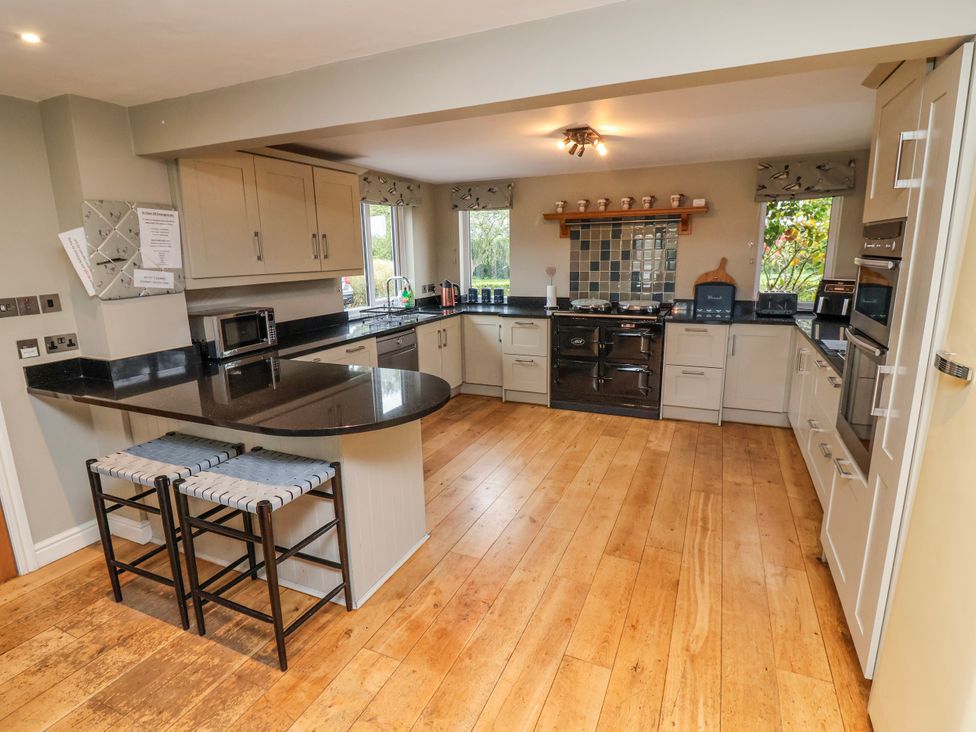 A kitchen with appliances and countertop space at Manor Wood Farndon