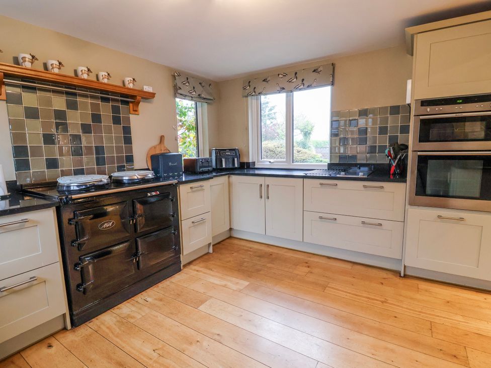 A kitchen with a window and appliances at Manor Wood Farndon