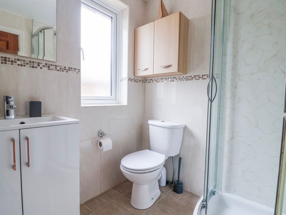 A bathroom with a toilet and sink at Manor Wood in Farndon