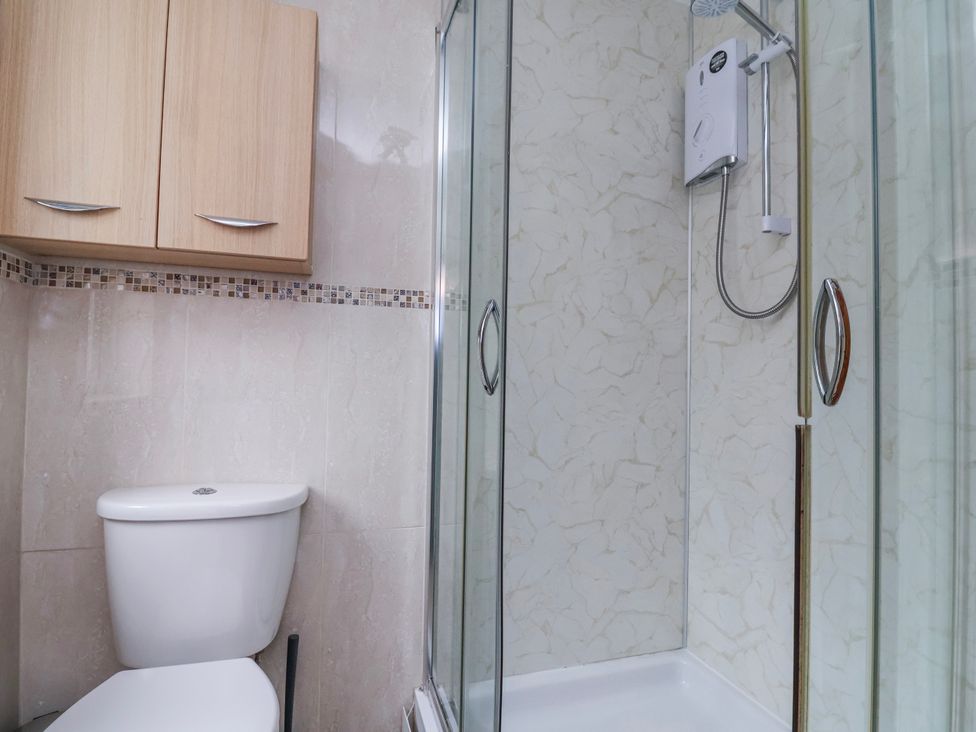A bathroom with a shower and a toilet at Manor Wood in Farndon