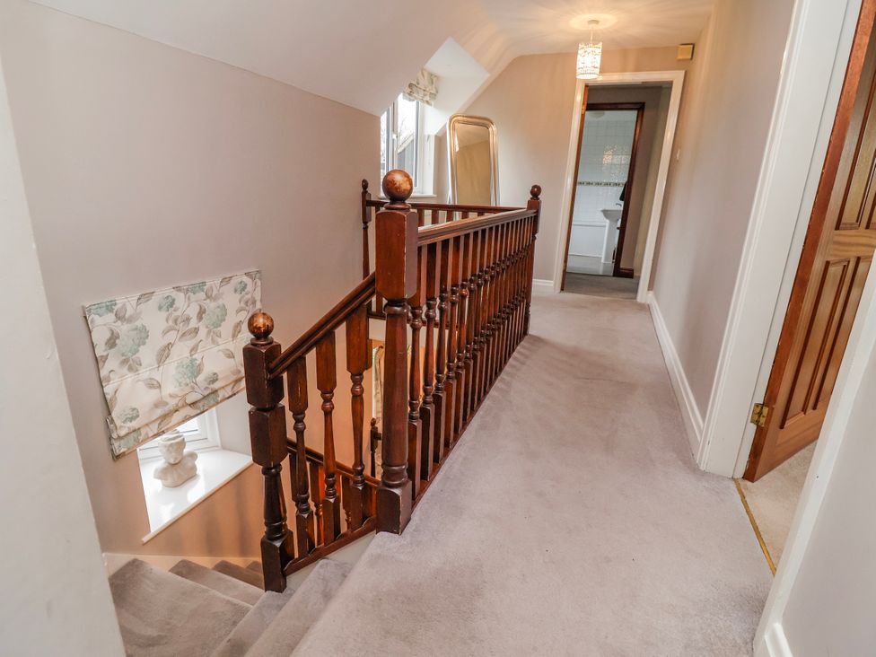 A staircase leading to a hallway at Manor Wood in Farndon