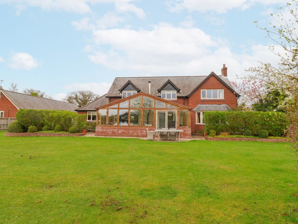 A house with a conservatory and garden at Manor Wood Farndon