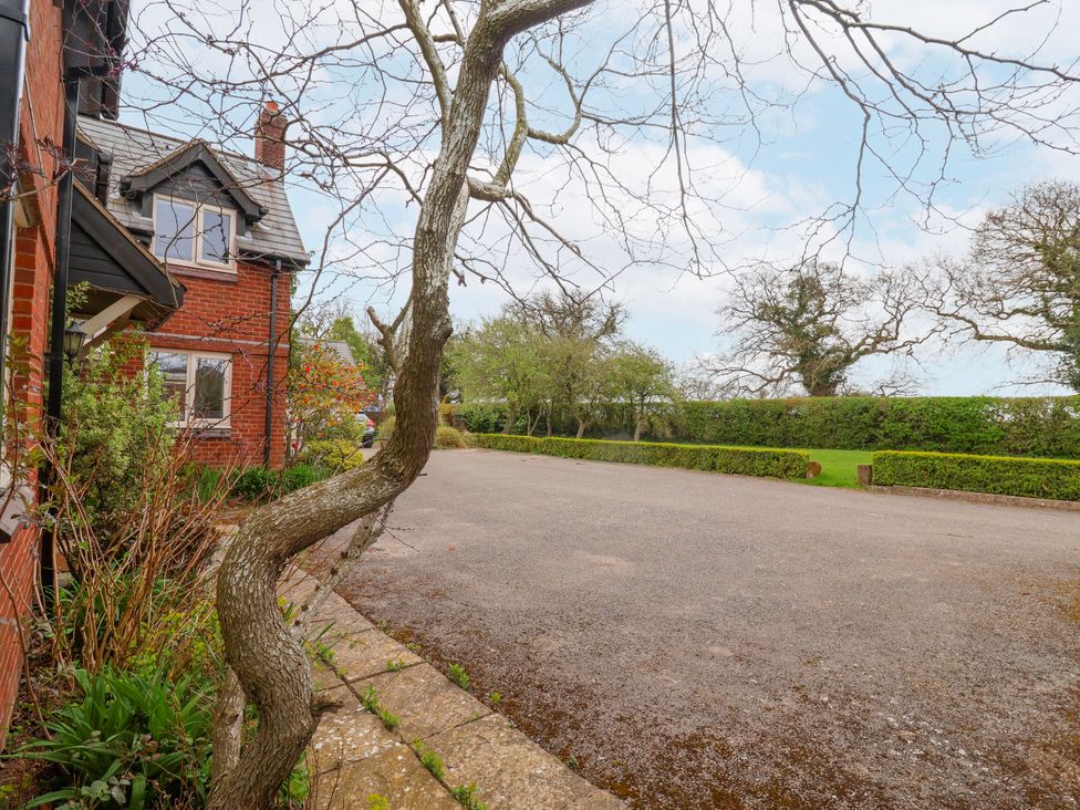 An outdoor view of a house with a driveway at Manor Wood Farndon