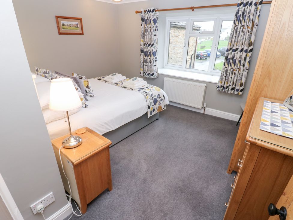 A bedroom with a bed and window at Braeside in Reeth