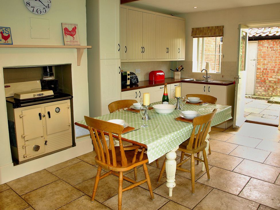A kitchen with a table and chairs at COO - Beaconsfield Cottage in Melton Constable