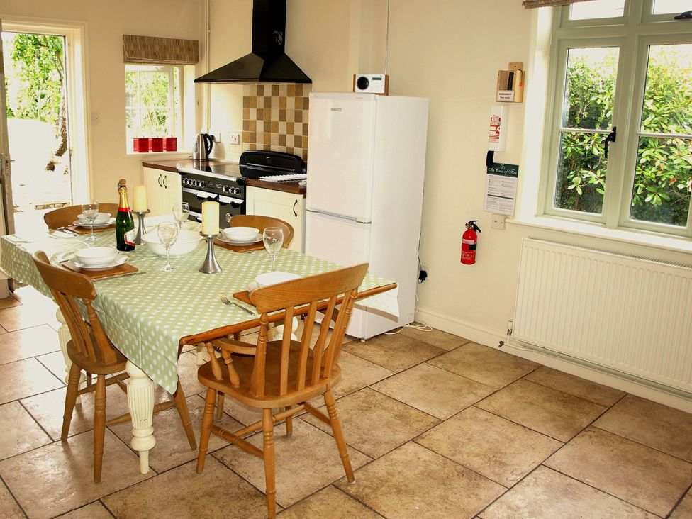 A kitchen with a dining table and chairs at COO - Beaconsfield Cottage Melton Constable