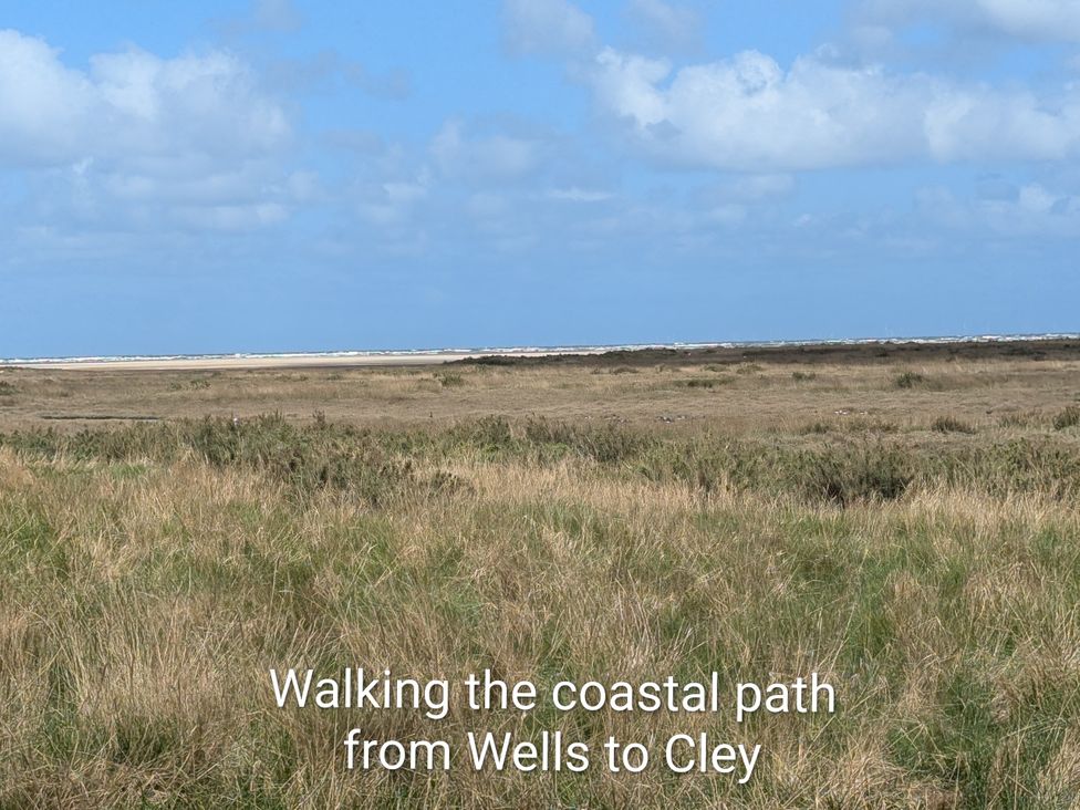A coastal path with grass and blue sky at Beaconsfield Cottage in Briston