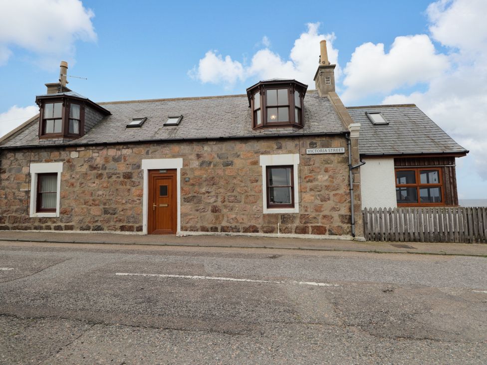 A house with stone wall and windows at Seascape in Portknockie