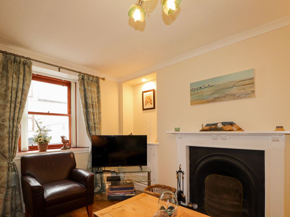 A living room with a fireplace and tv at Seascape in Portknockie