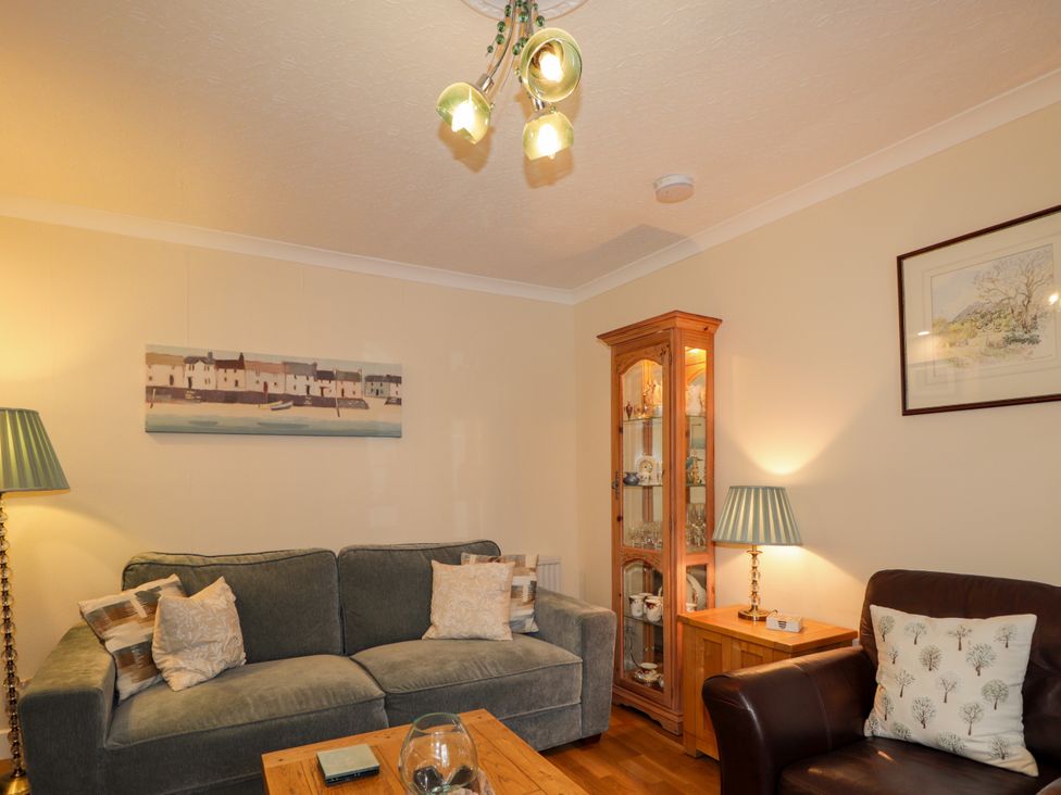 A living room with a sofa and table at Seascape in Portknockie