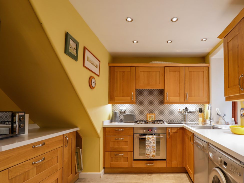 A kitchen with cabinets and appliances at Seascape in Portknockie