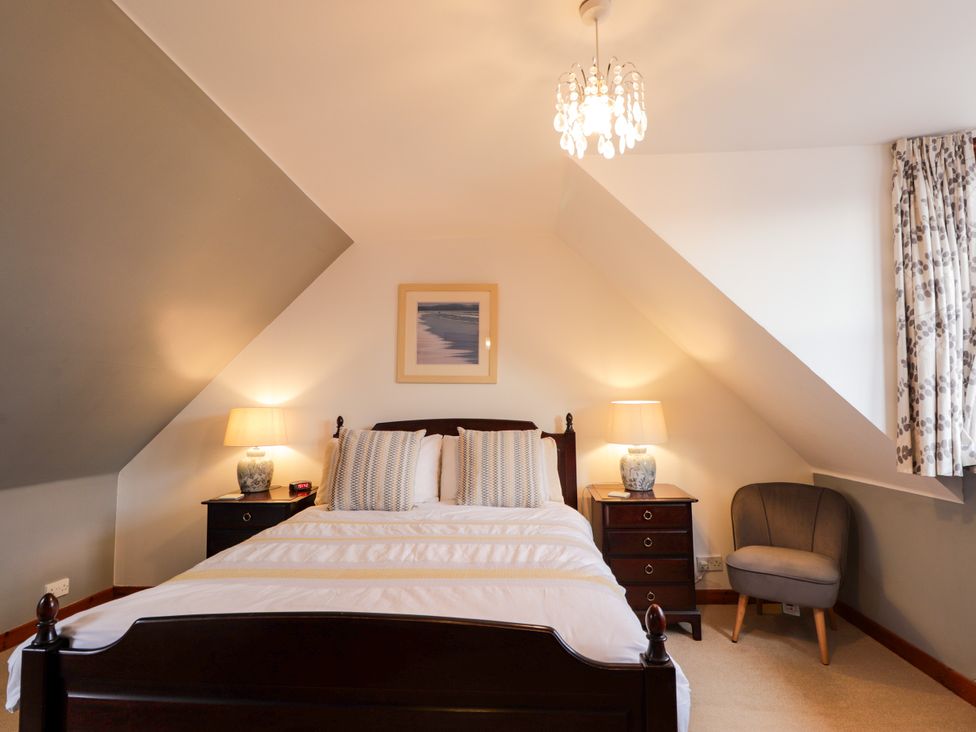 A bedroom with a bed and bedside table at Seascape in Portknockie