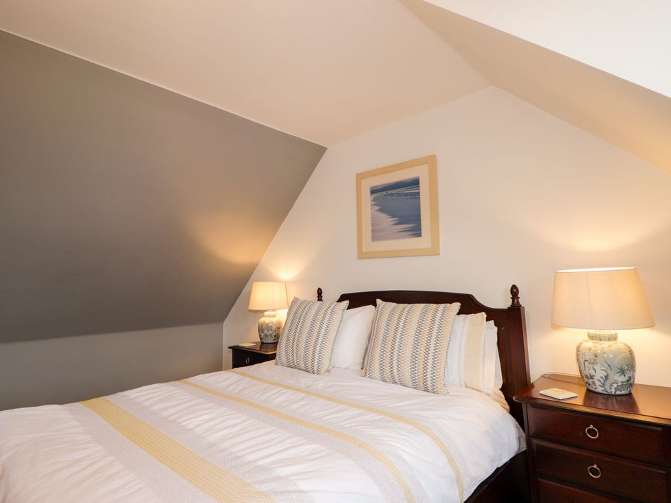 A bedroom with a bed and nightstand at Seascape in Portknockie