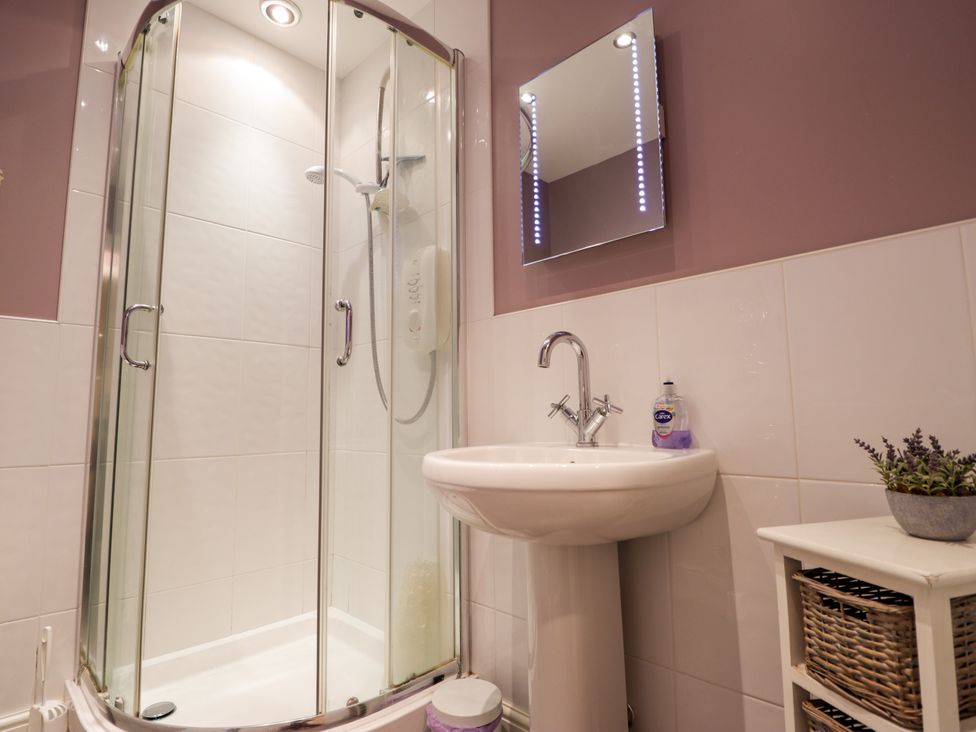 A bathroom with a shower and sink at Seascape in Portknockie