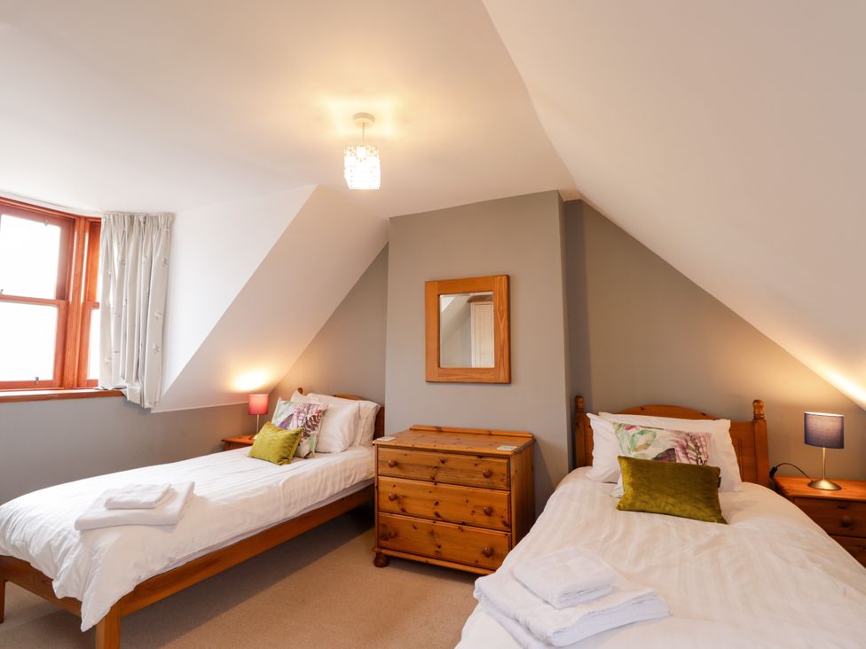 A bedroom with two single beds and a dresser at Seascape in Portknockie