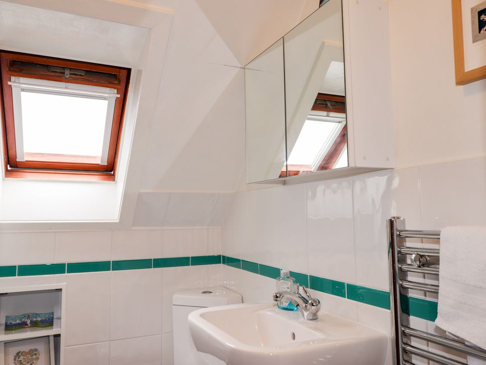 A bathroom with a sink and window at Seascape in Portknockie