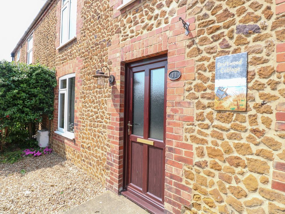 A front door with a sign at Driftwood Cottage in Heacham