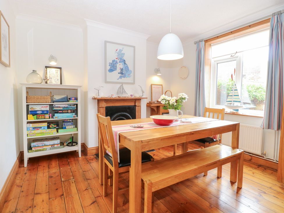 A dining room with a table and chairs at Driftwood Cottage Heacham
