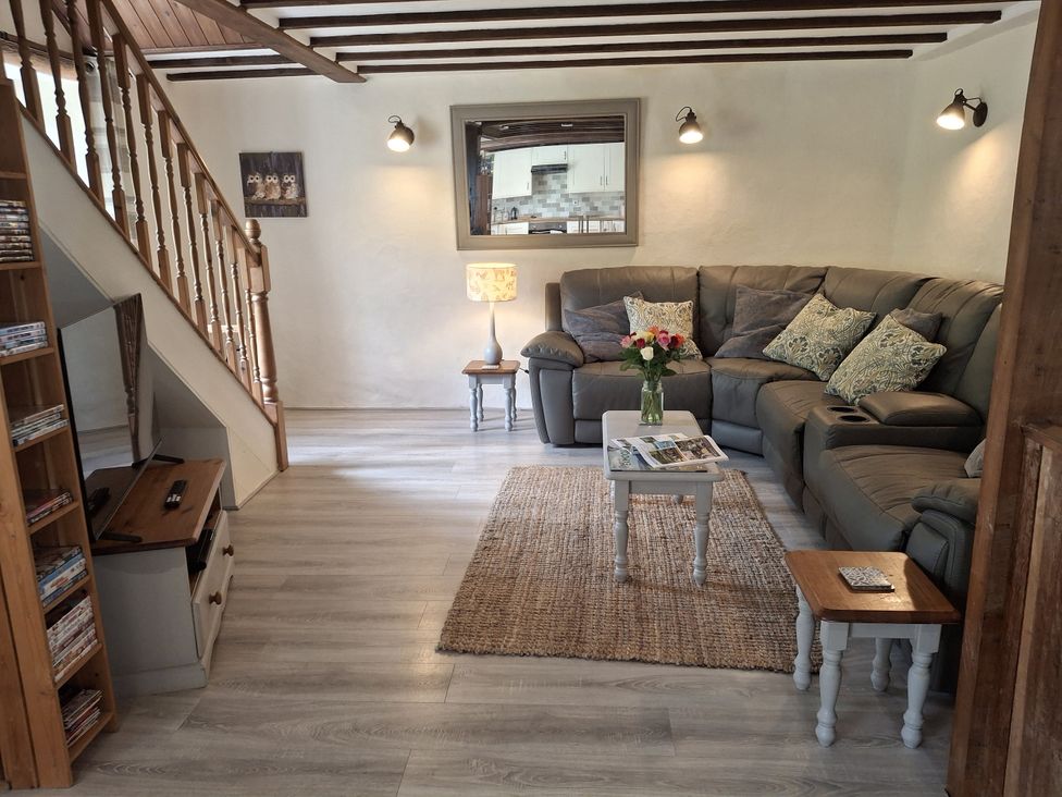 A living room with a sofa and coffee table at Owl's Nest in South Molton