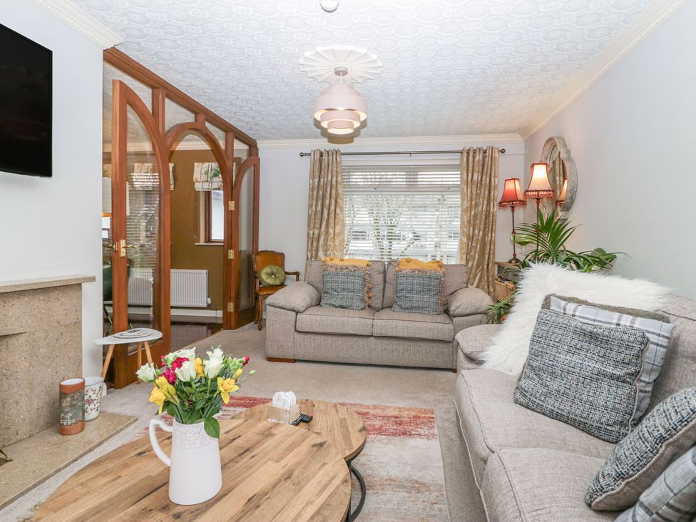 A living room with sofas and a coffee table at Kempton in Bowness-on-Windermere
