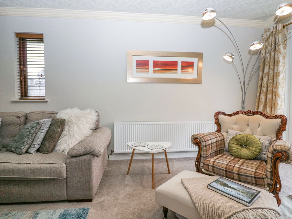 A living room with sofa and armchair at Kempton Bowness-on-Windermere