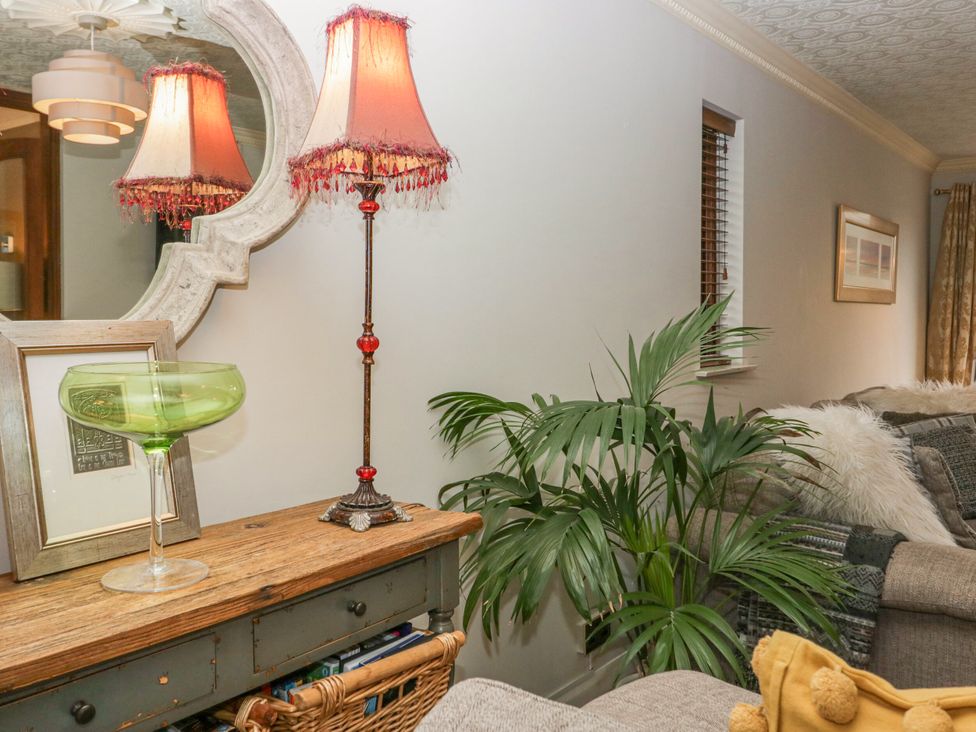 A living room with a lamp and a plant at Kempton in Bowness-on-Windermere