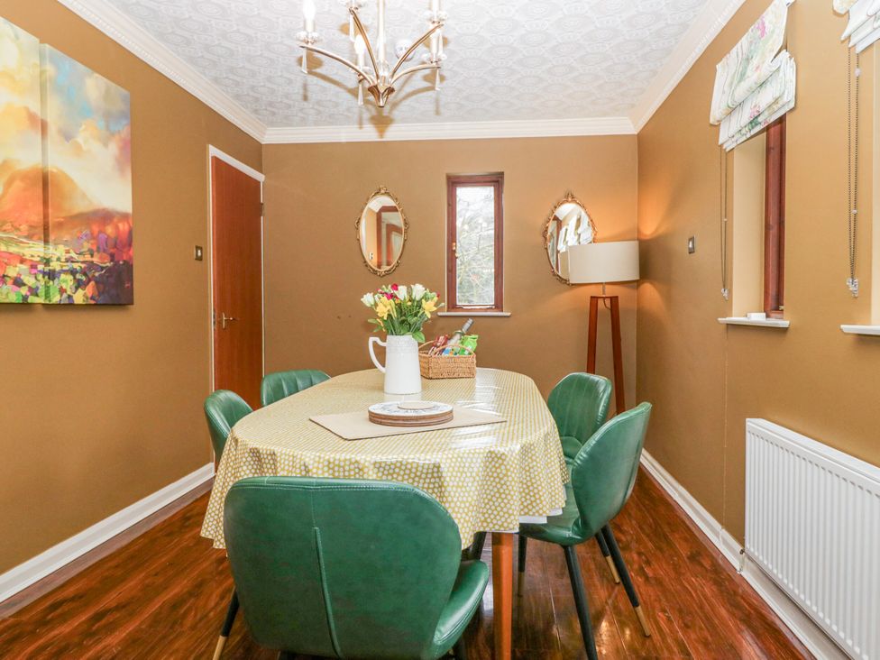 A dining room with a table and chairs at Kempton in Bowness-on-Windermere
