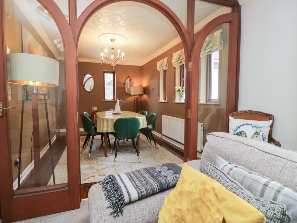 A dining room with a table and chairs at Kempton in Bowness-on-Windermere