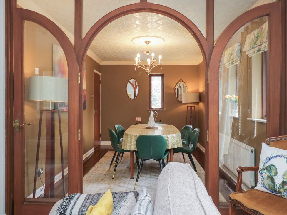 A dining room with a table and chairs at Kempton in Bowness-on-Windermere