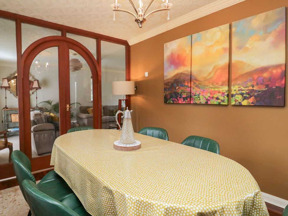 A dining room with a table and chairs at Kempton in Bowness-on-Windermere