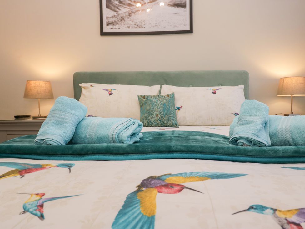 A bedroom with a bed and pillows at Kempton in Bowness-on-Windermere